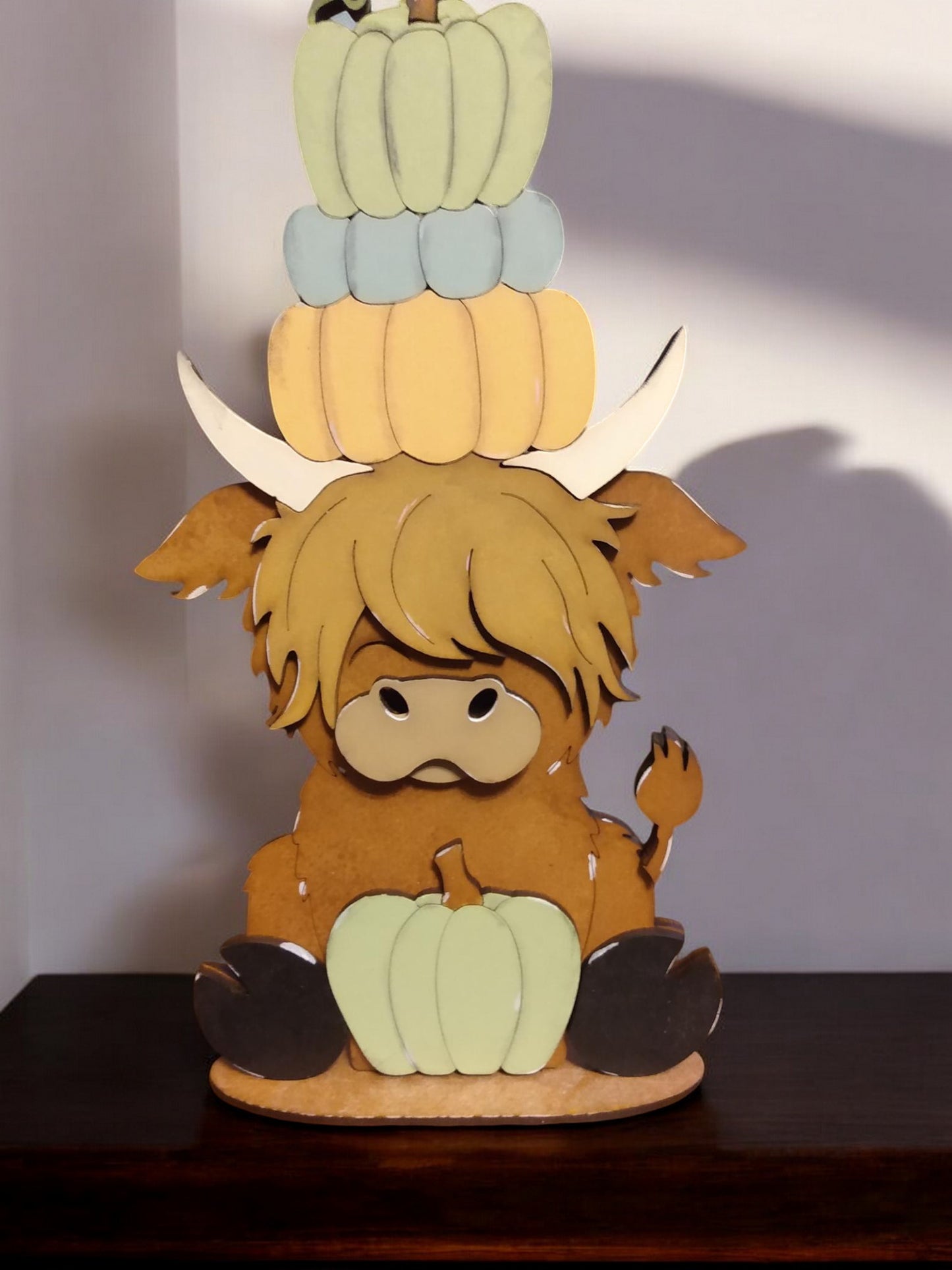 Highland cow shelf sitter with pumpkins